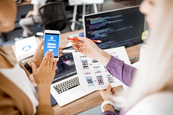 A group of people looking at a phone login screen