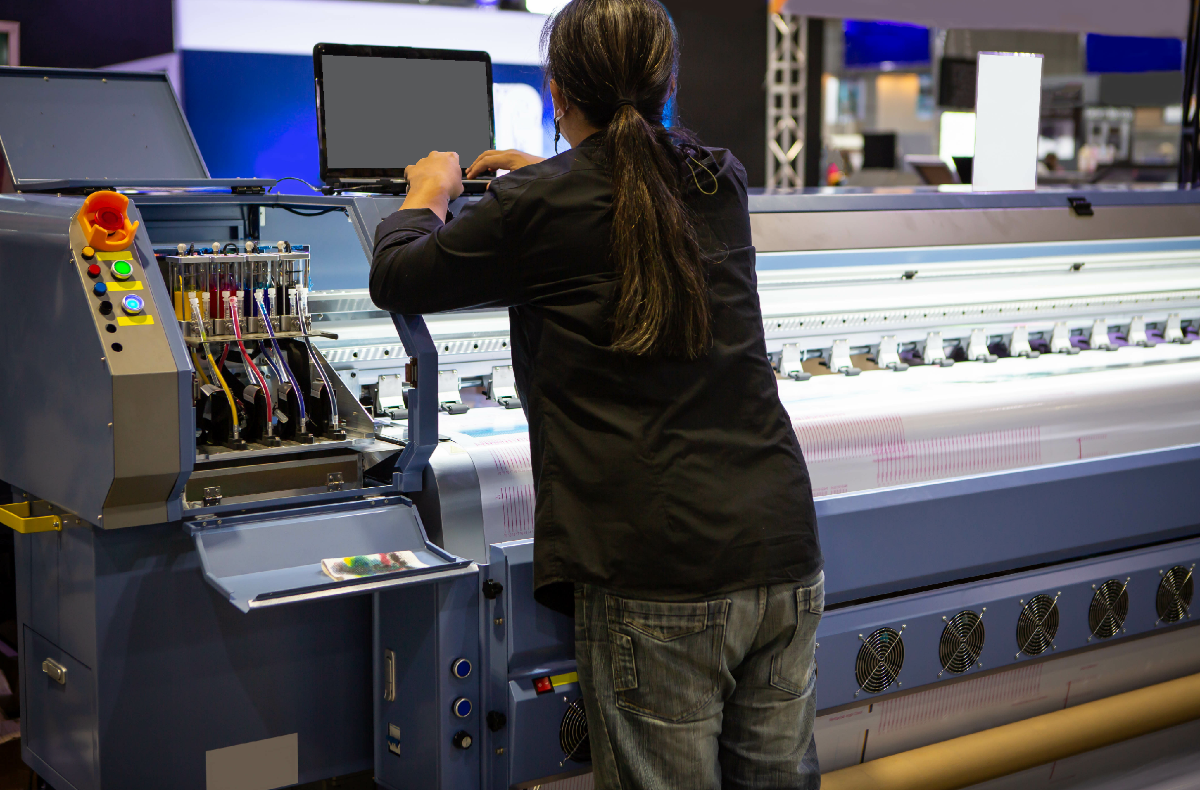 Industrial technician operating wide format digital inkjet printer