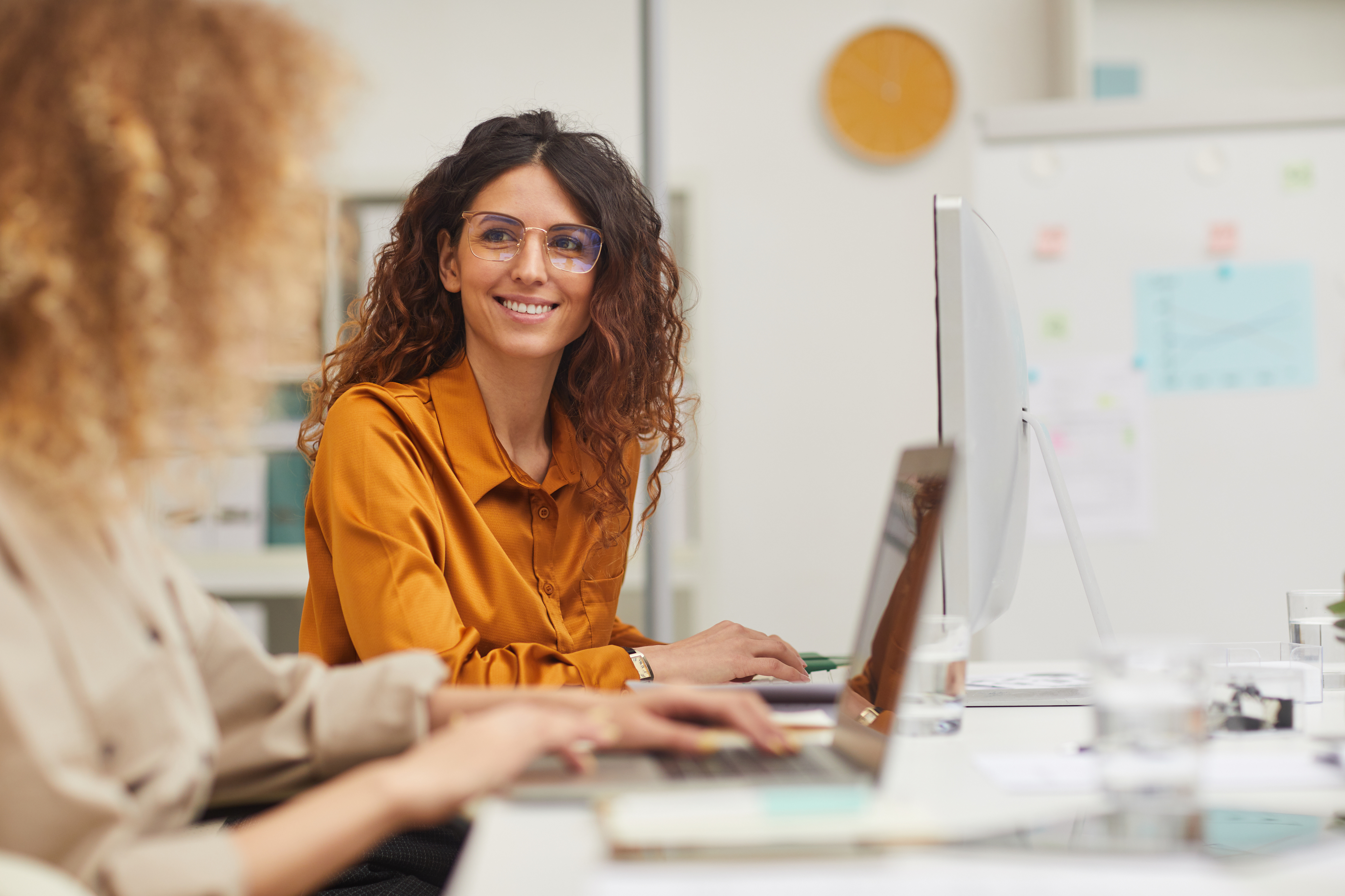 Two women interacting while working in an office