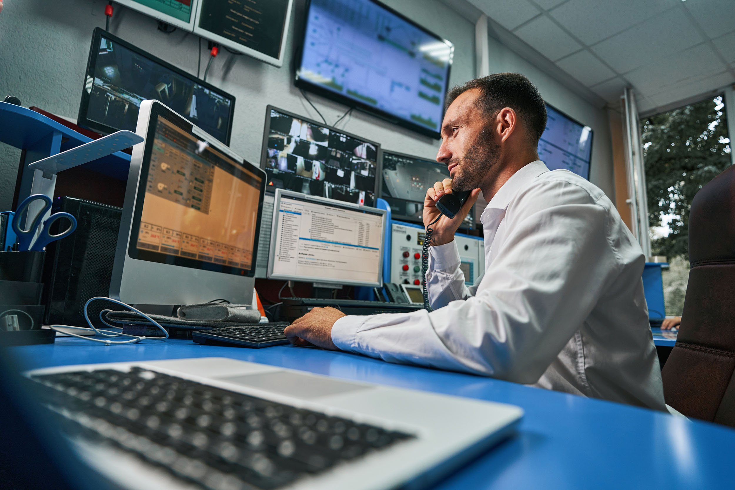 Server technician answering phone call from control room