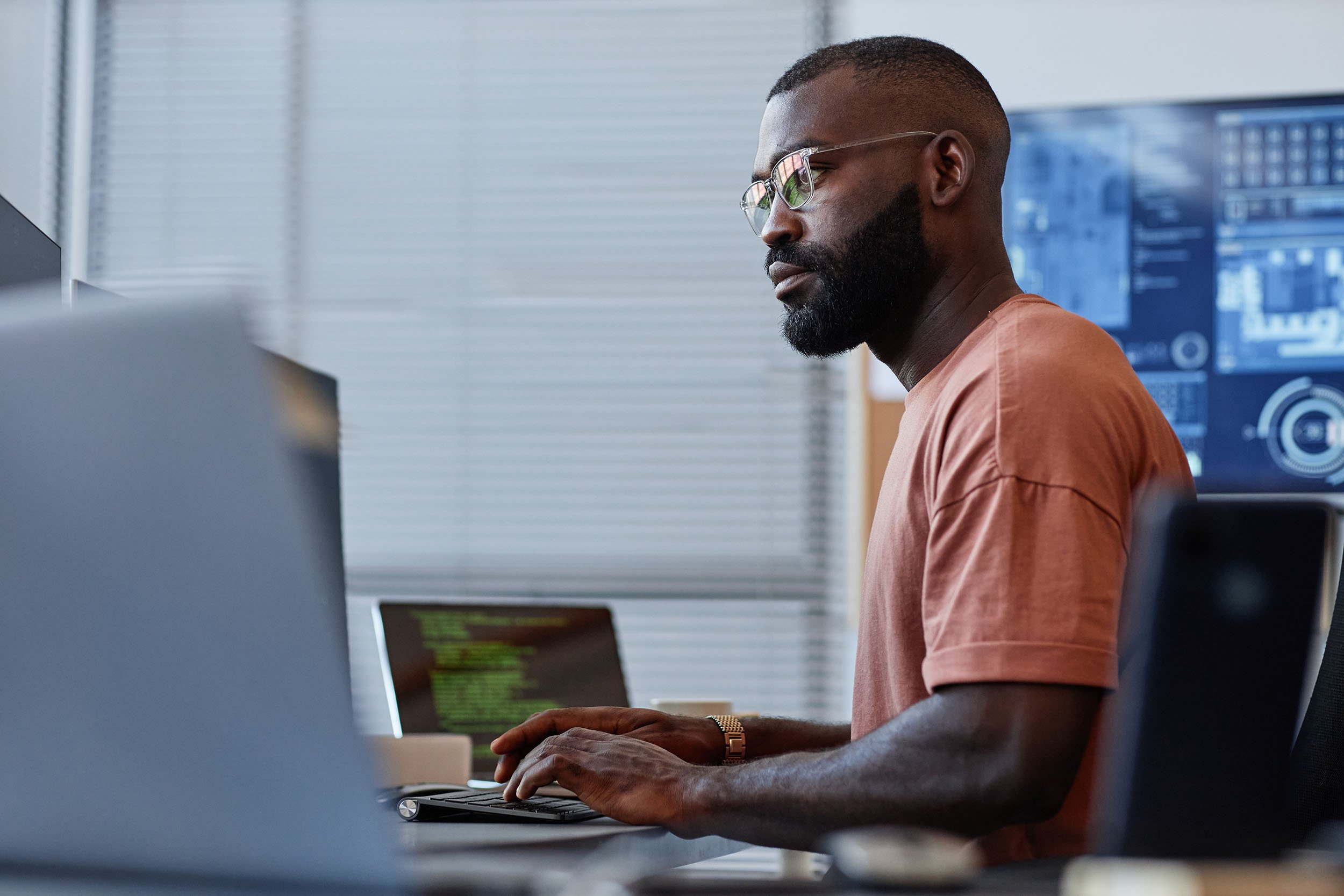 Software developer using computer in high technology office