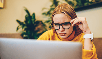Confused engineer looking at laptop
