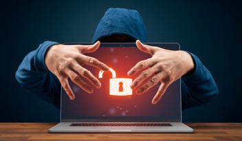 Hacker with hands over a computer screen
