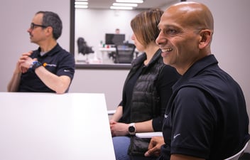 group of people around a table talking