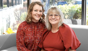 Lisa Watson and Kathy Willhite pose for a picture in front of a window