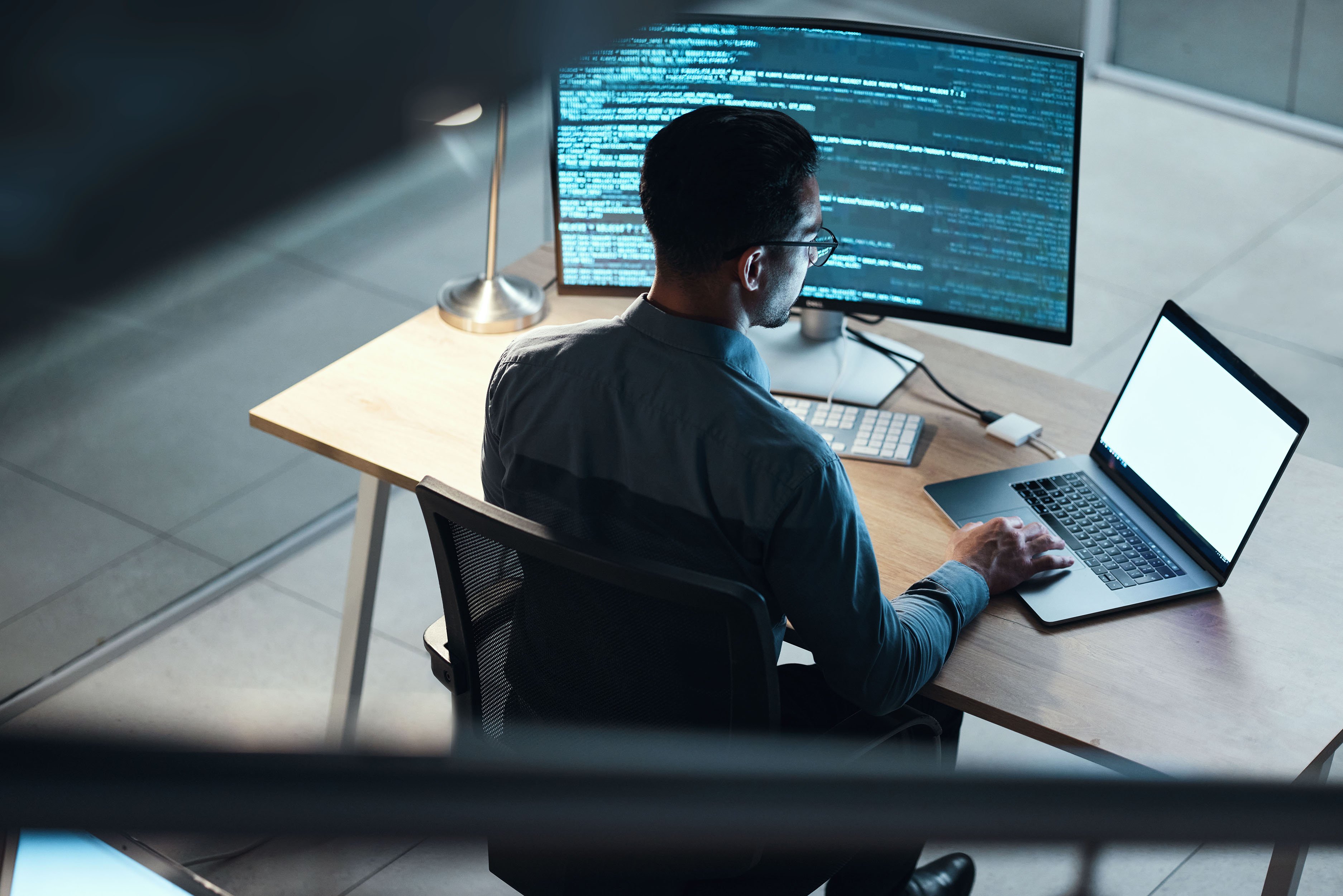 Man coding at night on laptop screen