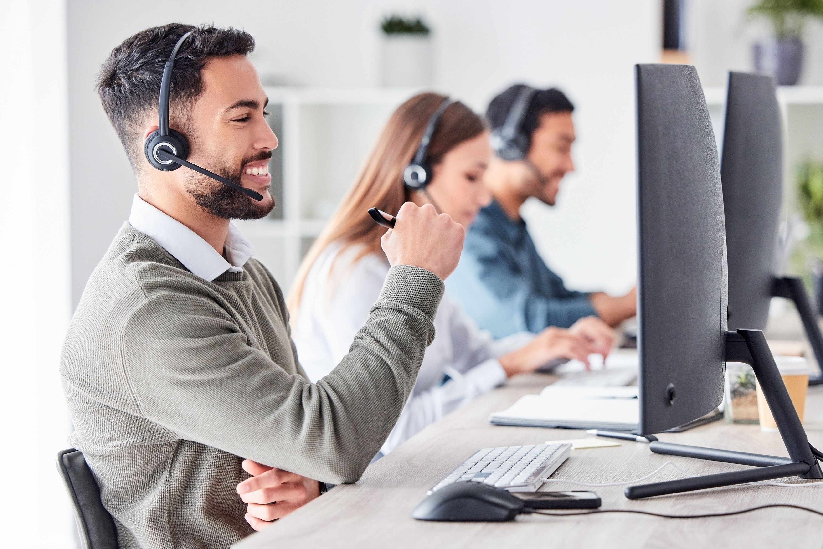 Man working in team office with headset