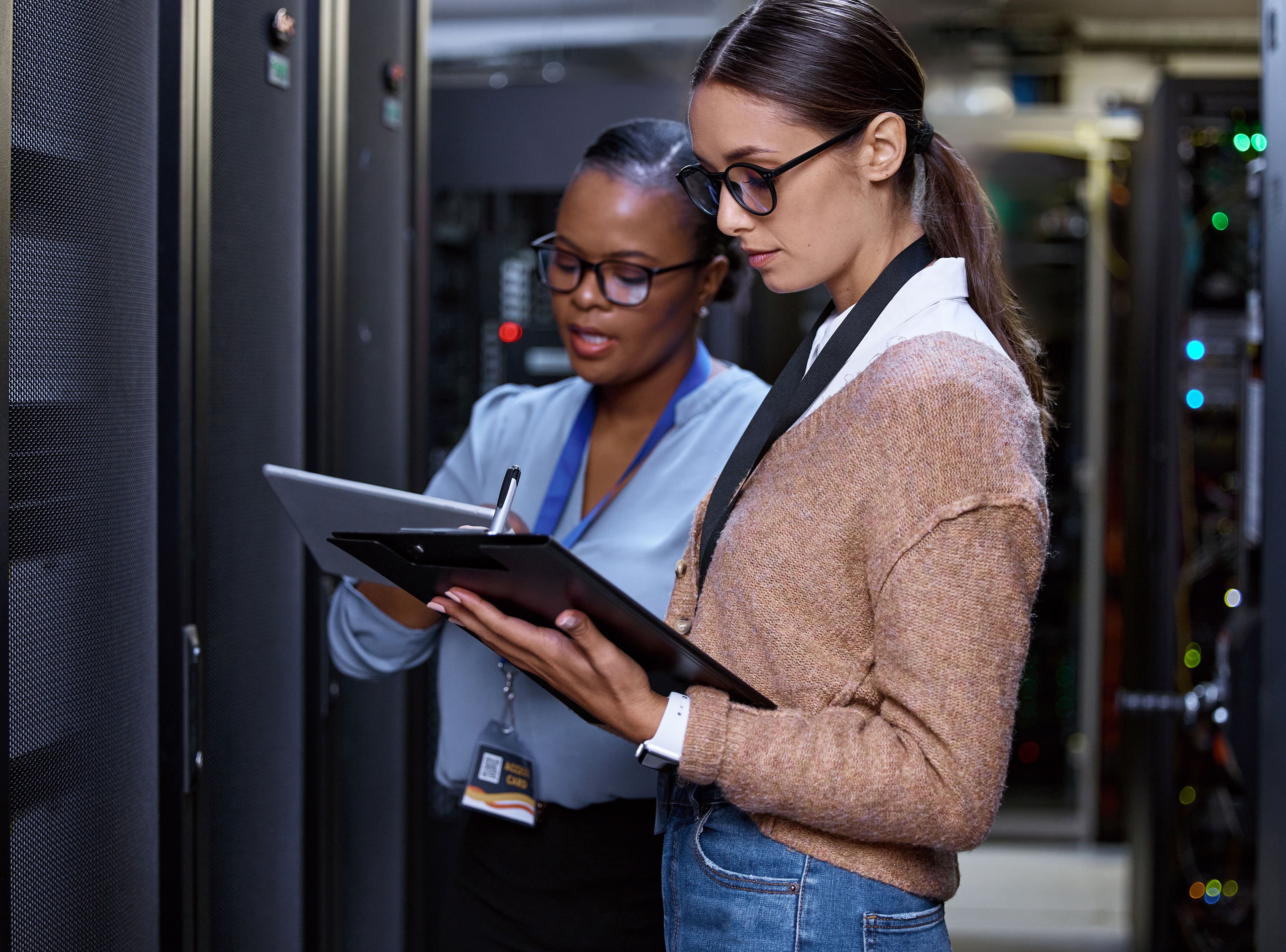 Two young female computer programmers working together