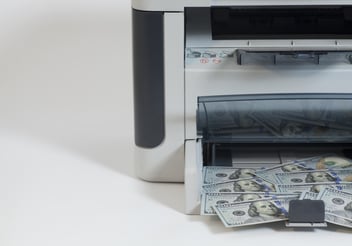 dollar bills coming out of a printer