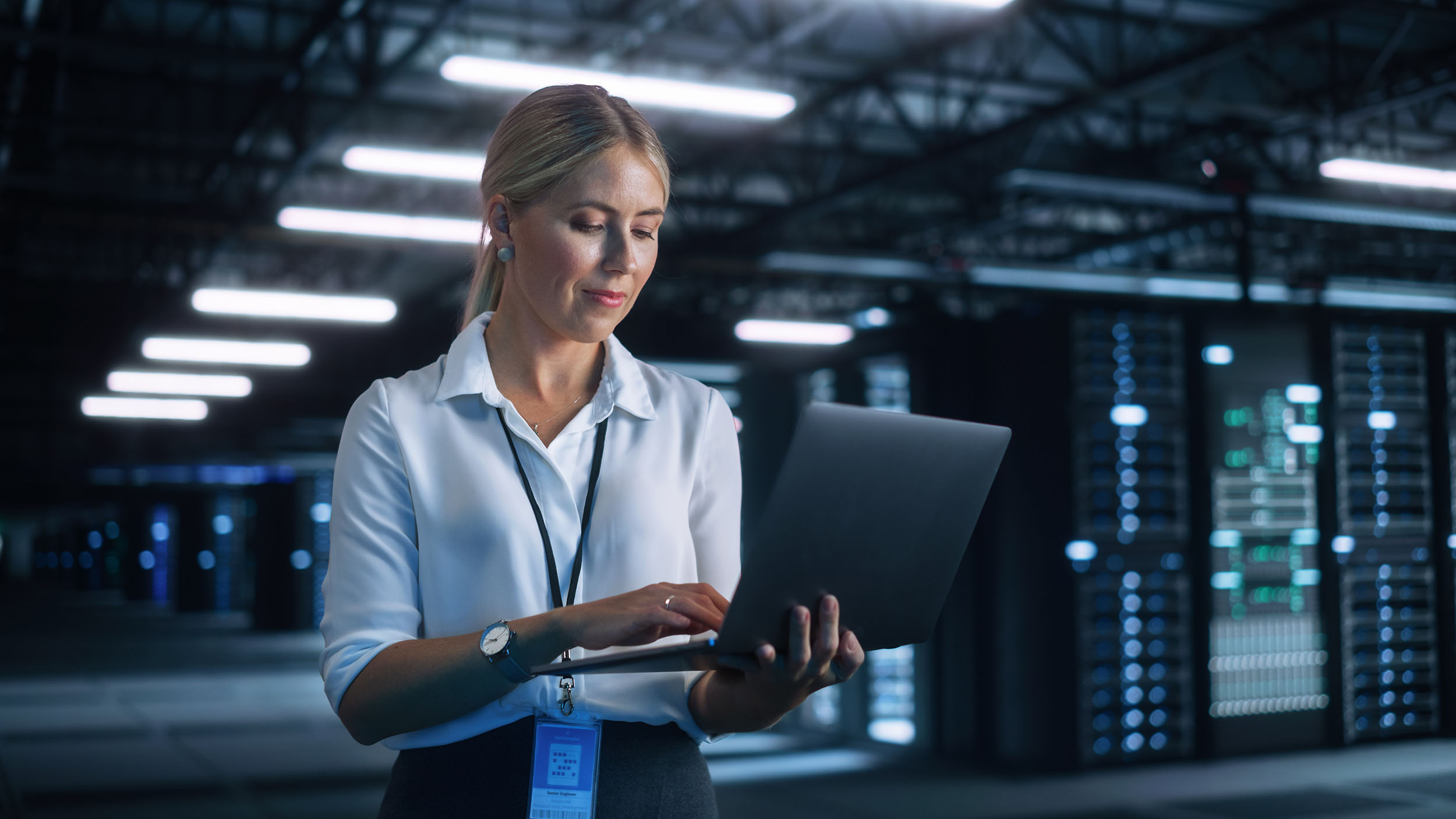 Woman using laptop to optimize server farm