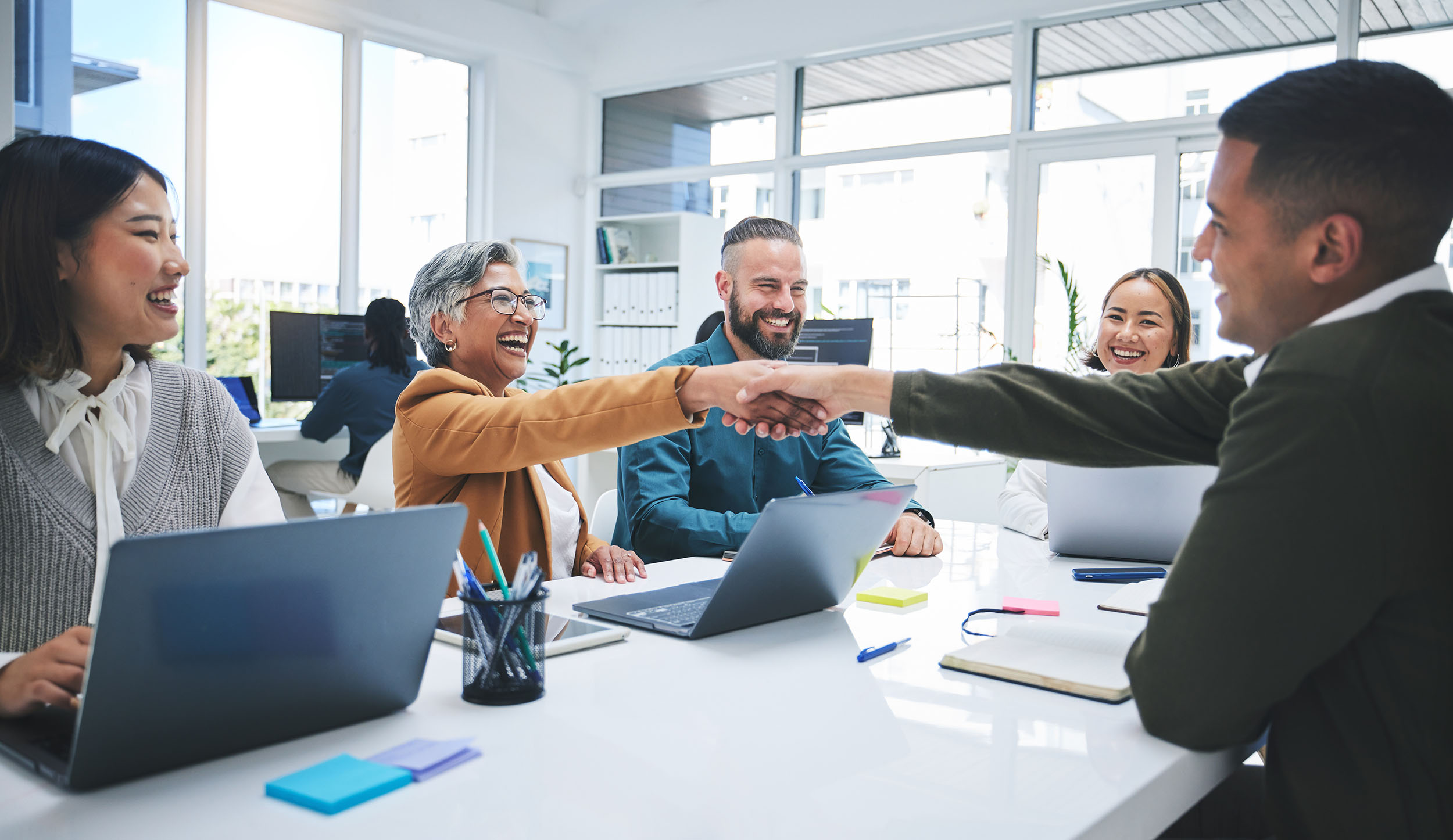 Group of employees shaking hands in recruiting