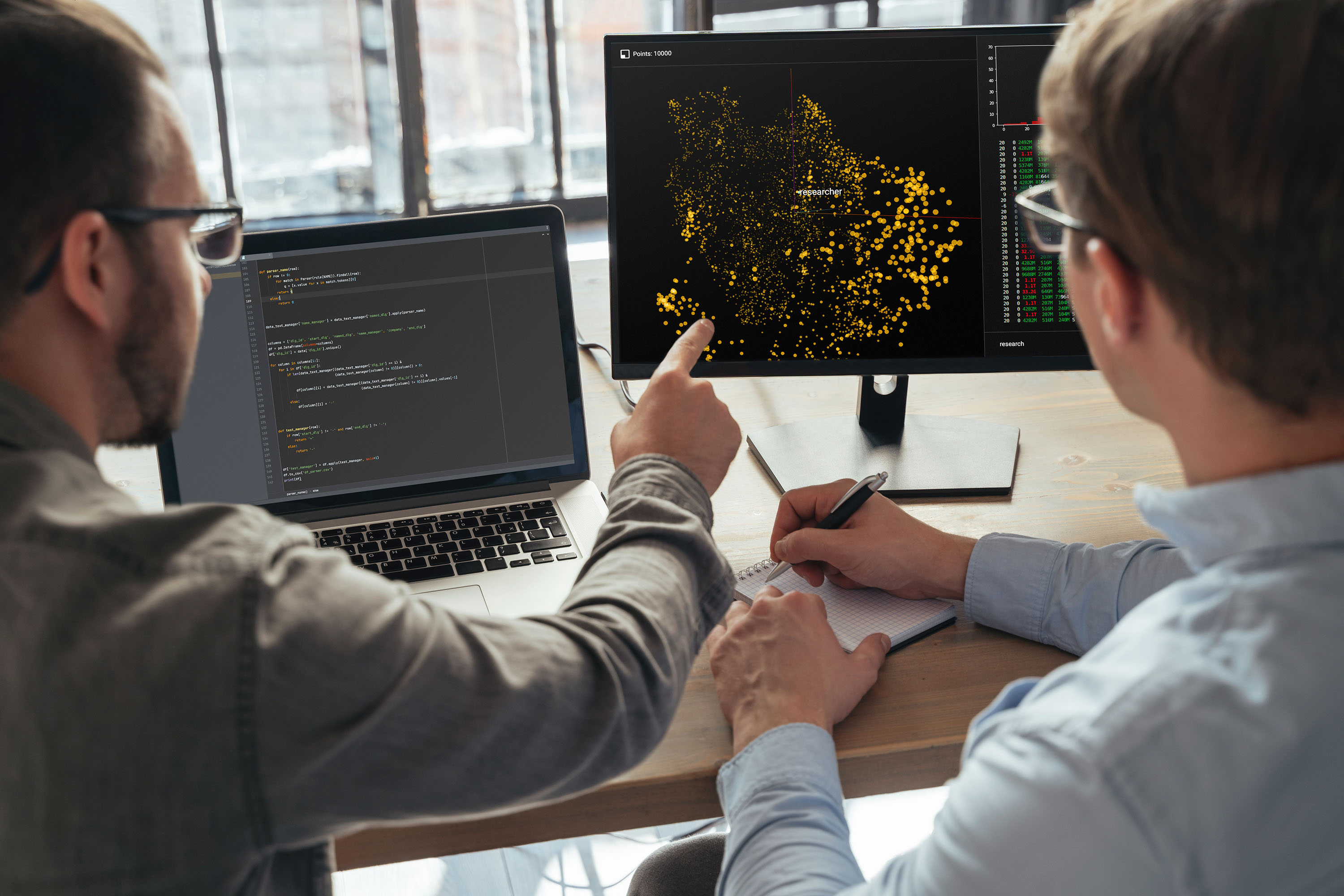 Closeup of two men data science specialists working at office together